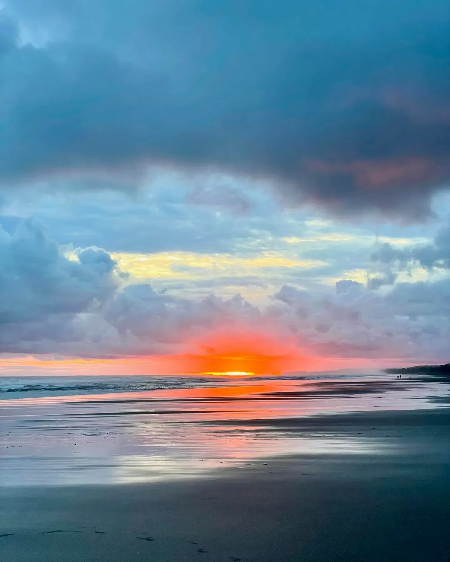 Pacific waves breaking along the shore at sunset