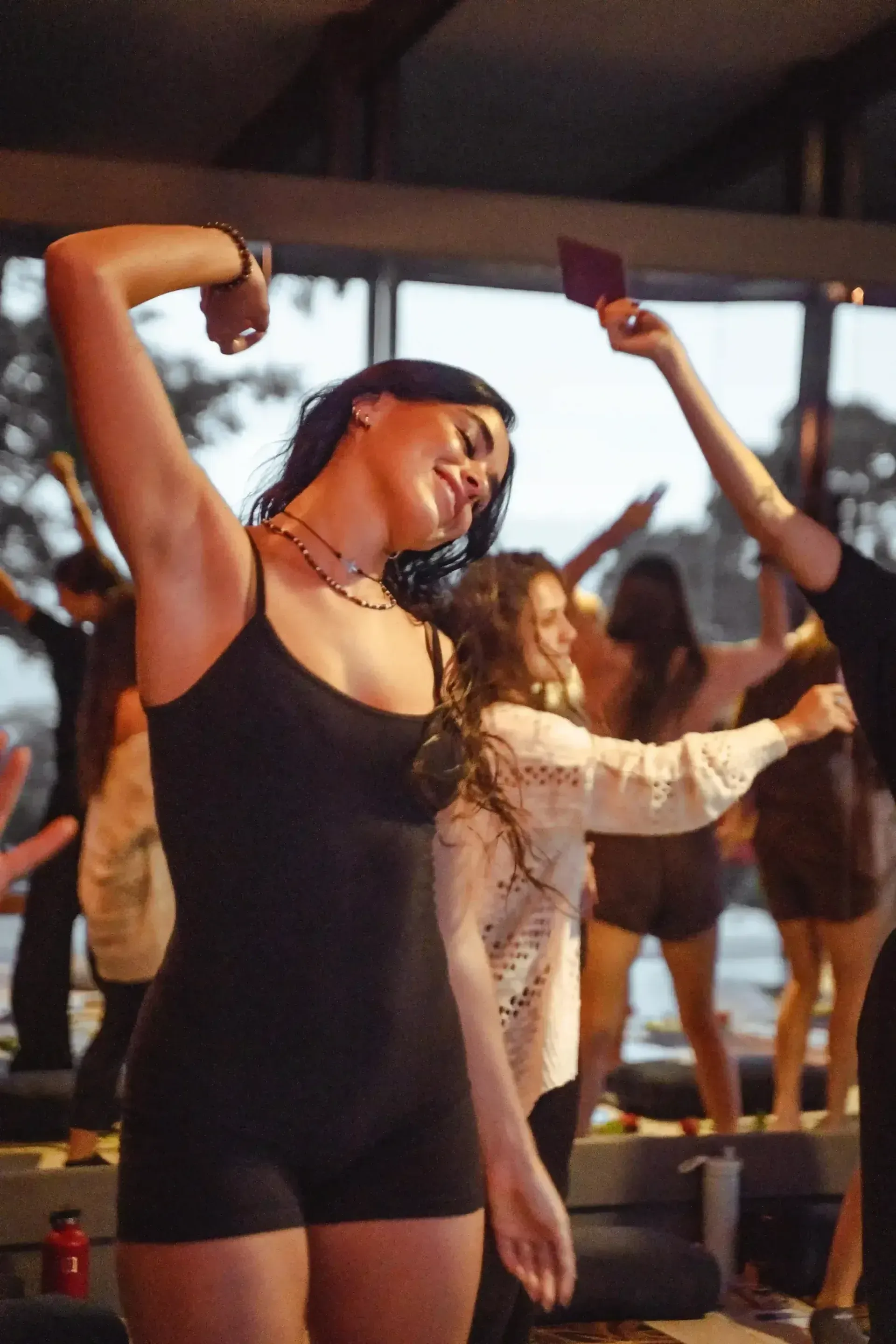 Guests dancing under warm festoon lights at a gala night.